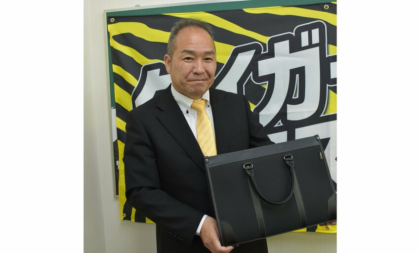 贈られた黒のかばんを大事そうに抱える河村さん