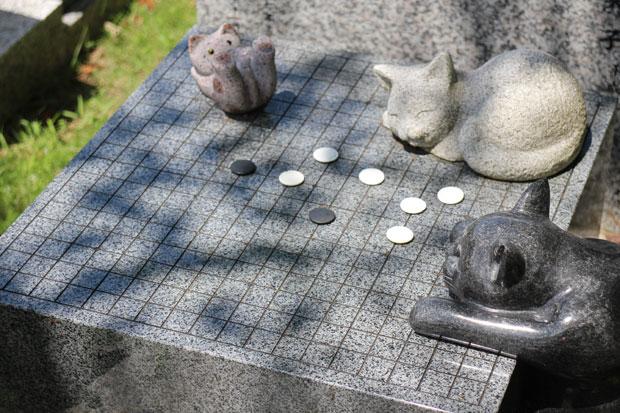 碁盤の上に猫ちゃんたちがいる、オリジナル墓石。ちゃんと碁石ものっかっている（撮影／ライター・福光恵）