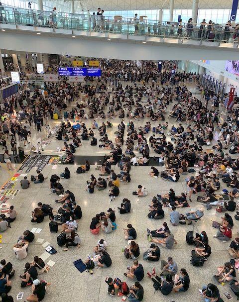 香港国際空港のロビーで座り込むデモ隊＝8月13日