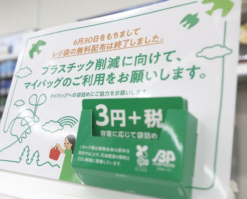 レジ袋が有料となり、コンビニのレジ近くには告知のパネルが設置された (c)朝日新聞社