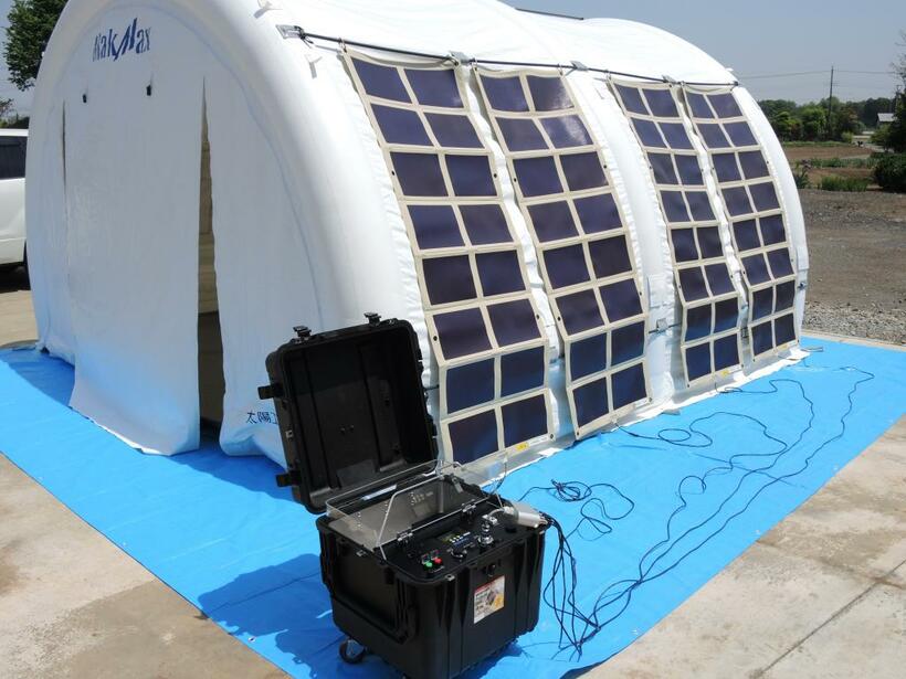 フィルム状の太陽電池を貼った非常用テント。災害時にはスマートフォンの充電も可能（写真提供：太陽工業）