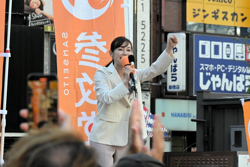 参院選の投開票から一夜明け、街頭でマイクを握る参政党のさや氏=2025年7月21日午後4時25分、東京都港区