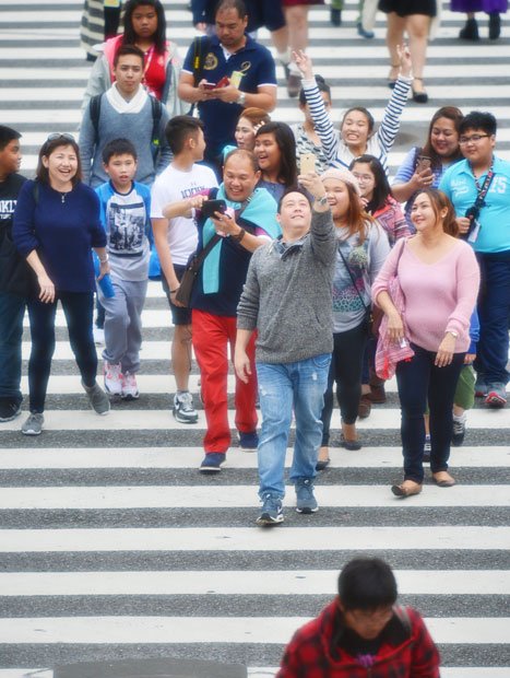 渋谷スクランブル交差点大勢の歩行者が整然と道路を横断する光景が人気。交差点を見下ろす喫茶店のテラス席は、終日カメラを構えた外国人が並ぶ（撮影／写真部・東川哲也）
<br />