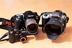 右から、ペンタックスK20D、ペンタックスK10D。それぞれシグマ50ミリF1.4とリミテッドレンズのタクマー31ミリF1.8をつけて、単焦点レンズの味わいを楽しんでいる。また縦位置撮影時に安定するのと長時間撮影用にバッテリーパックが装備されている。手前は、ニコンCOOLPIX　P5100