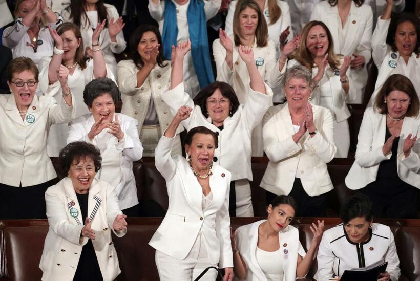 白い服を着て、女性の連帯を示す民主党の女性議員たち。政策の成果を強調する演説内容に終始しらけ気味だったが、トランプ大統領が「女性の活躍」に触れると、全員が立ち上がり、ハイタッチや握手をしながら盛り上がった（写真：Gettyimases）