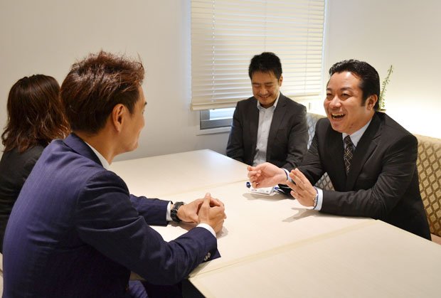 秋山さん（左手前）にプロポーズ成功を報告する藤井さん（右端）