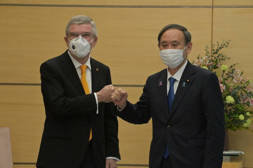 グータッチをするＩＯＣのバッハ会長（左）と菅首相　（ｃ）朝日新聞社