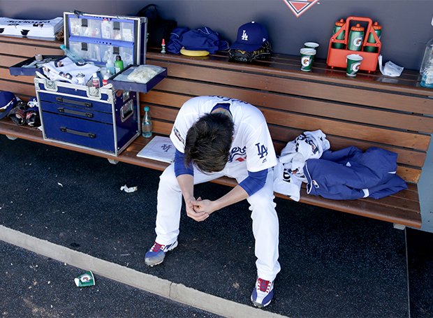 プレーオフ初登板で相手打線に打ち込まれ、ベンチでうなだれる前田健太（写真：Getty Images）