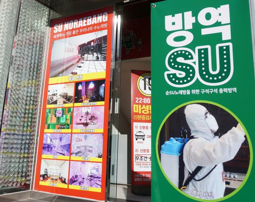 ソウルで若者が集う弘大にあるカラオケボックス。店の前には店内を消毒していることを示す表示が出ている=3月11日(C)朝日新聞社