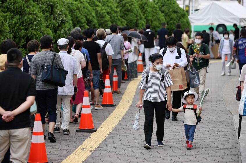 7月11日、安倍晋三元首相が銃撃された現場近くの献花台を訪れた人々／撮影・朝日新聞社